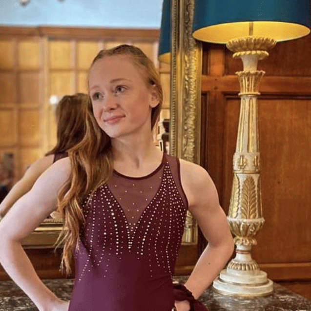 artistic gymnast in new style leotard in classic deep red